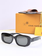 Louis Vuitton sunglasses, black square frames with tinted lenses and gold logo accents.