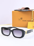 Louis Vuitton sunglasses with dark frames, purple-tinted lenses, and gold temple details.