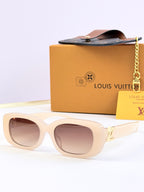 Louis Vuitton sunglasses, light beige frames with brown-tinted lenses and gold logo detail.