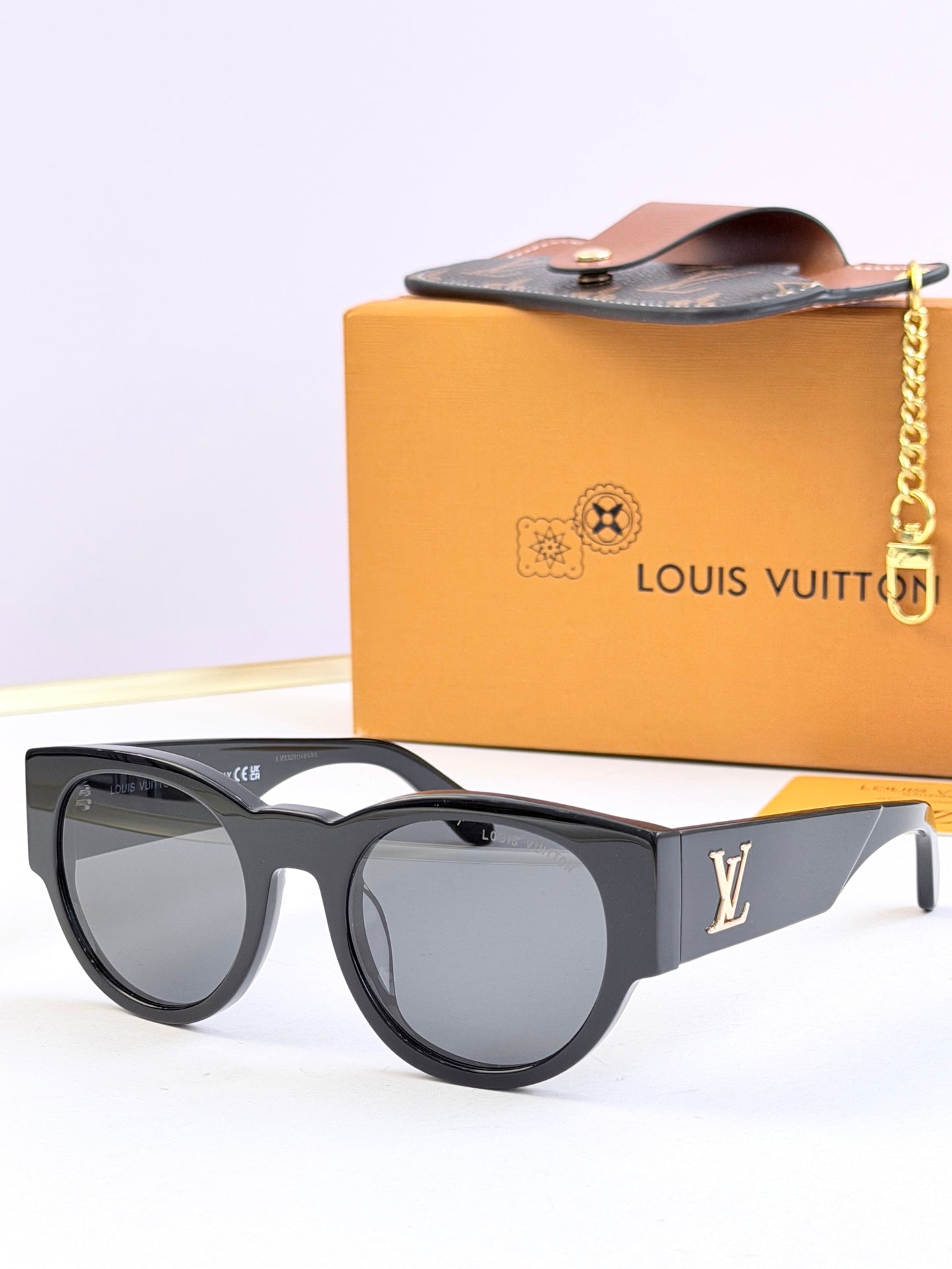 Louis Vuitton black round sunglasses with curved temples and dark tinted lenses