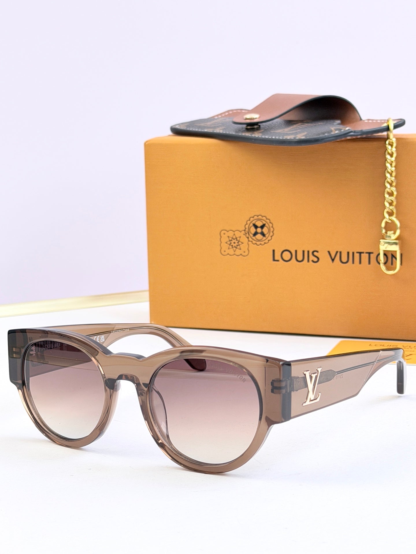 Louis Vuitton light brown sunglasses with mauve tinted lenses and LV side logo