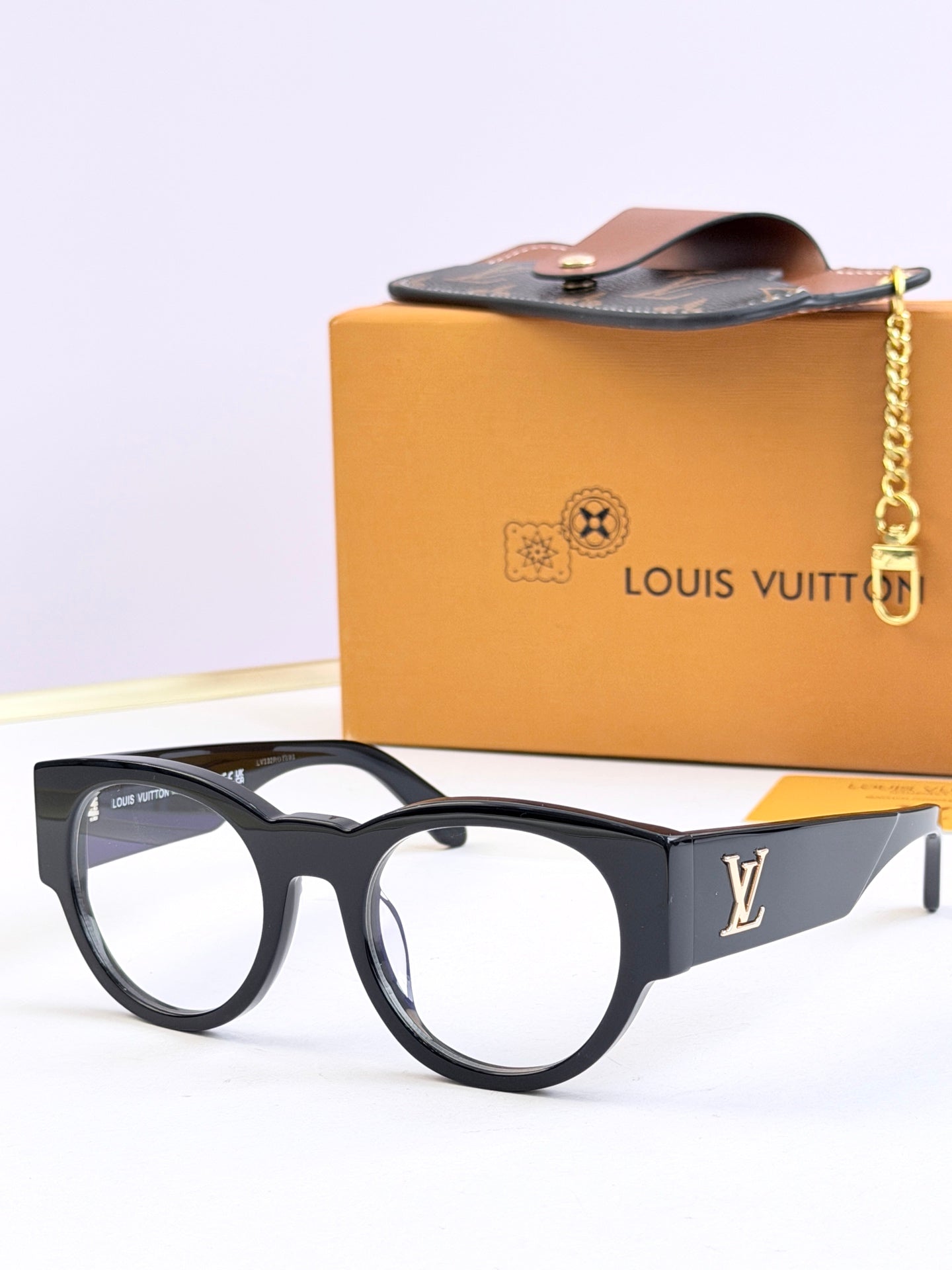 Louis Vuitton black sunglasses with smoke tinted lenses and LV side logo