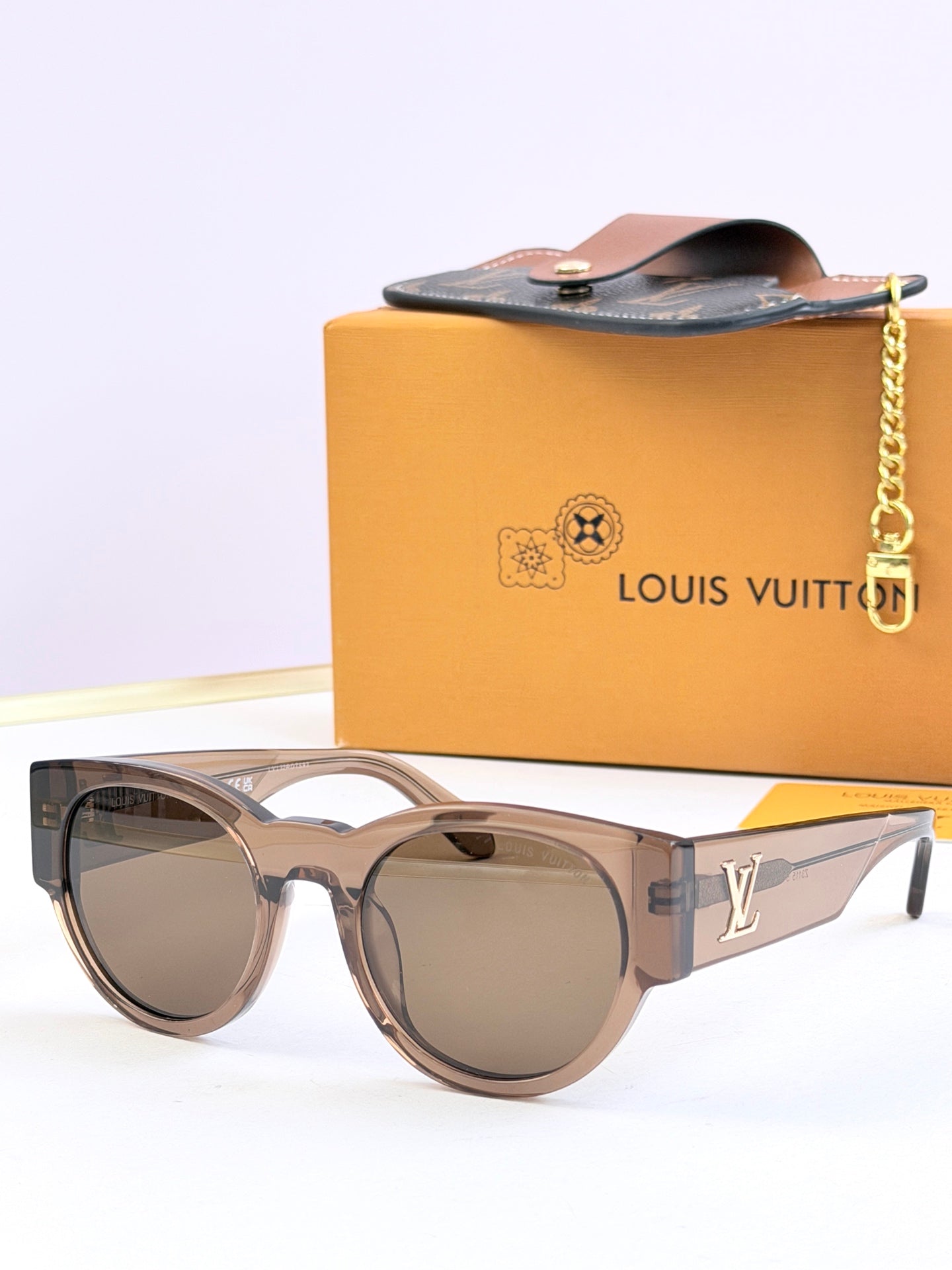 Louis Vuitton clear smoke sunglasses with brown tinted lenses and LV side logo