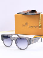 Louis Vuitton gray sunglasses with light blue tinted lenses and LV side logo