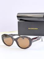 Oversized round sunglasses with tinted amber lenses and dark tortoise frame, BALENCIAGA