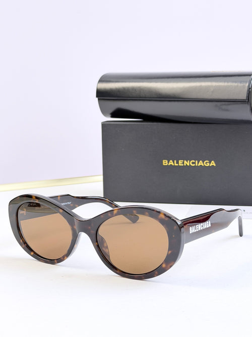 Oversized round sunglasses with tinted amber lenses and dark tortoise frame, BALENCIAGA