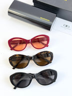 Three pairs of round sunglasses: red, tortoise, and black with tinted lenses