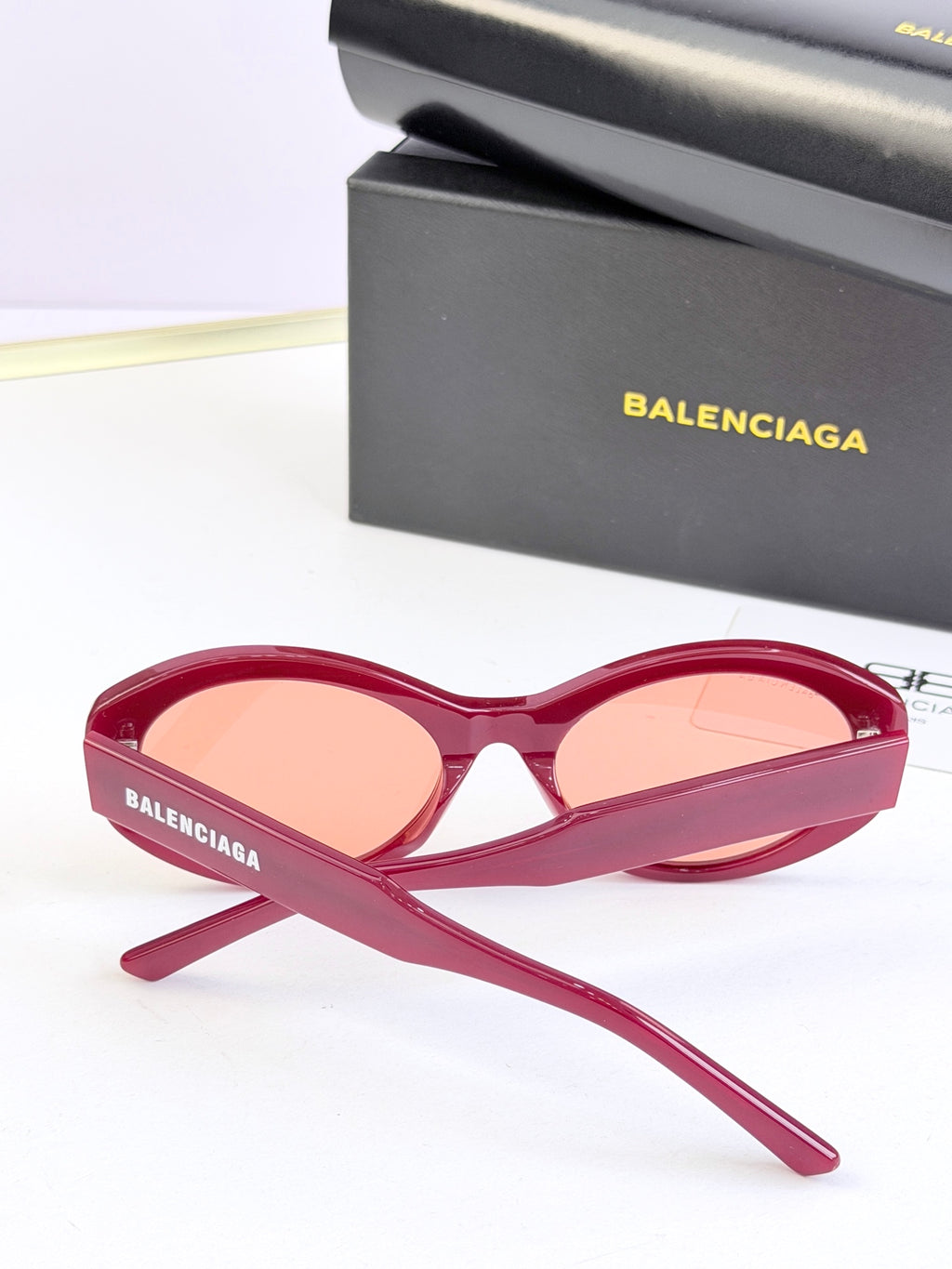 Pink oversized round sunglasses with peach lenses and BALENCIAGA logo on arms