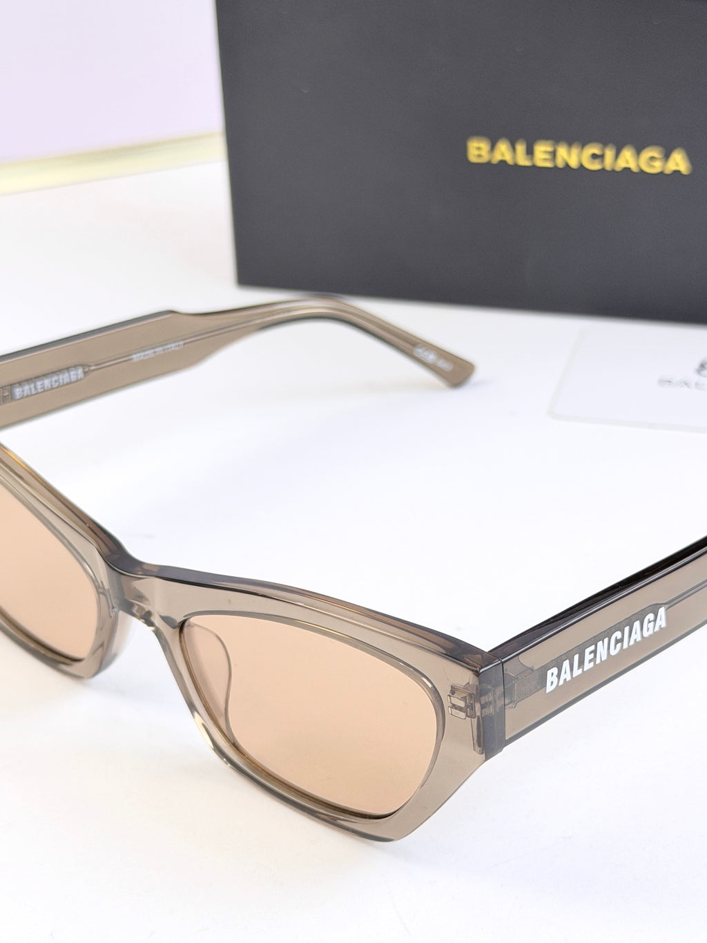 Balenciaga sunglasses, clear frame with light lenses, side view