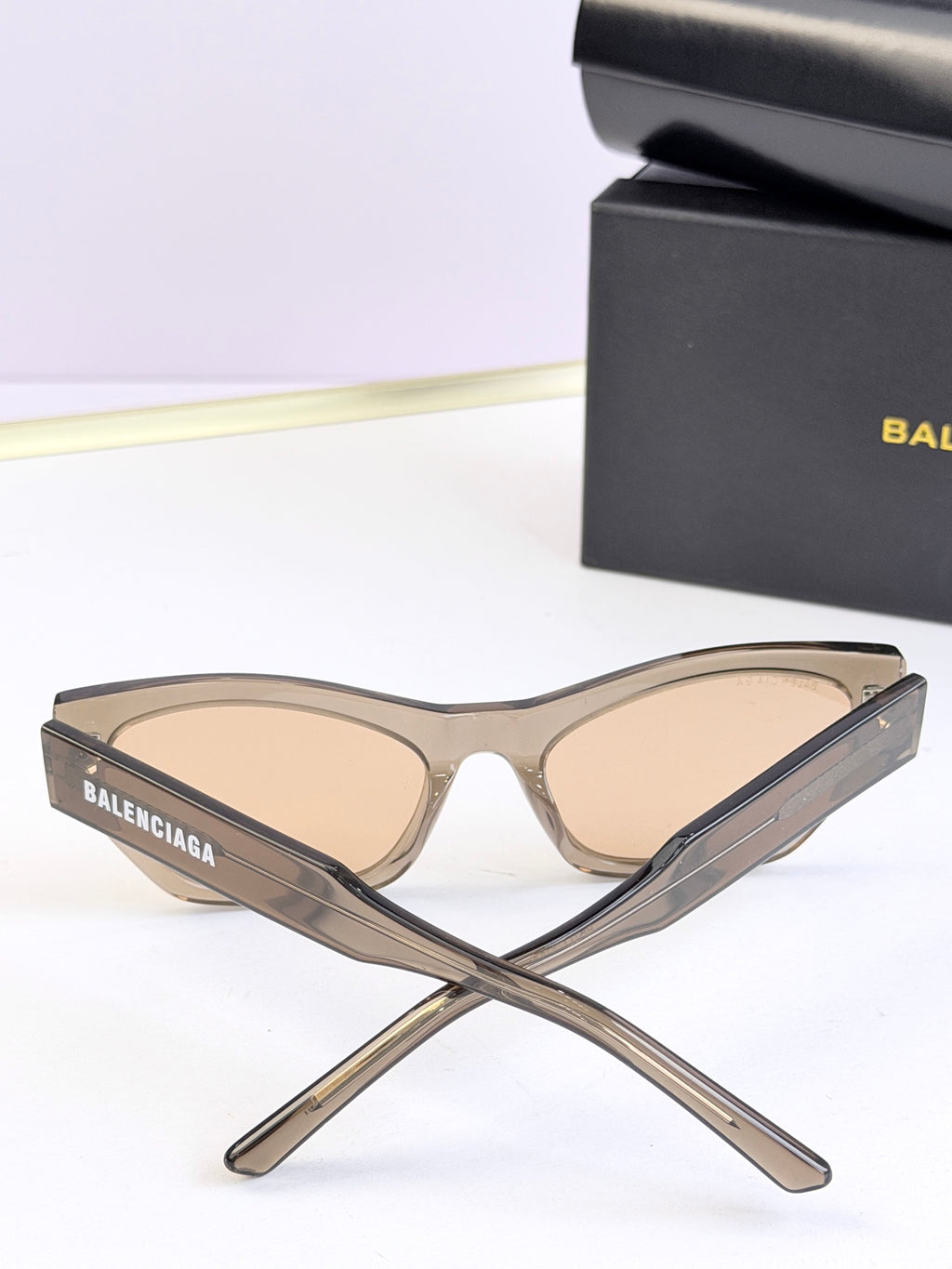 Balenciaga sunglasses, clear beige frame with light lenses, stacked