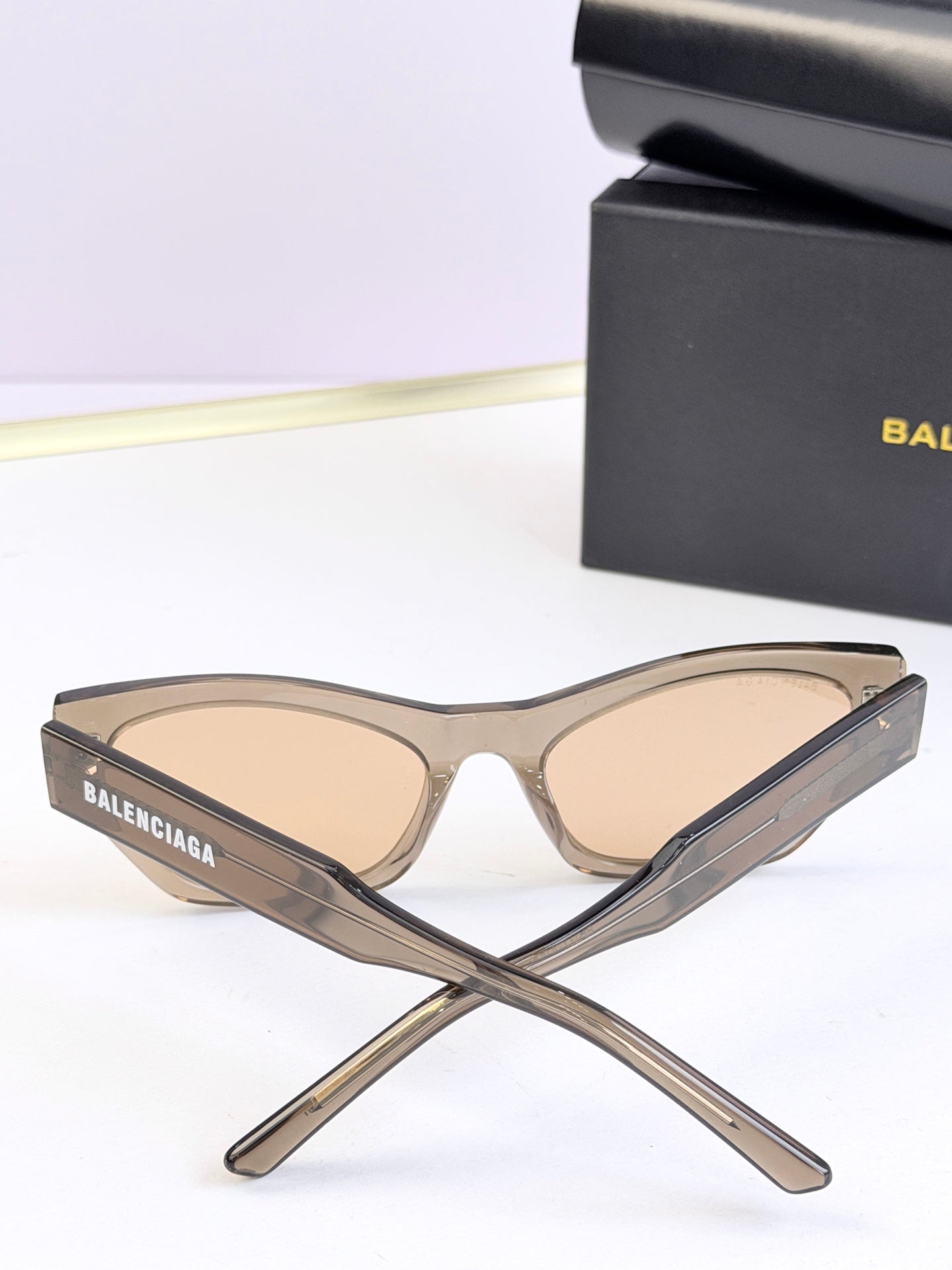 Balenciaga sunglasses, clear beige frame with light lenses, stacked