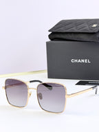 Chanel square sunglasses with gold frames and purple tinted lenses