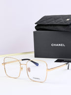 Chanel square eyeglasses with gold frames and subtle blue tinted lenses
