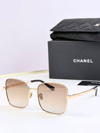 Chanel square sunglasses with gold frames and brown tinted lenses