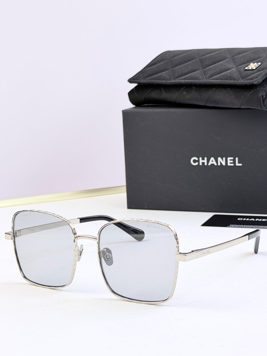 Chanel square eyeglasses with clear frames and light tinted lenses