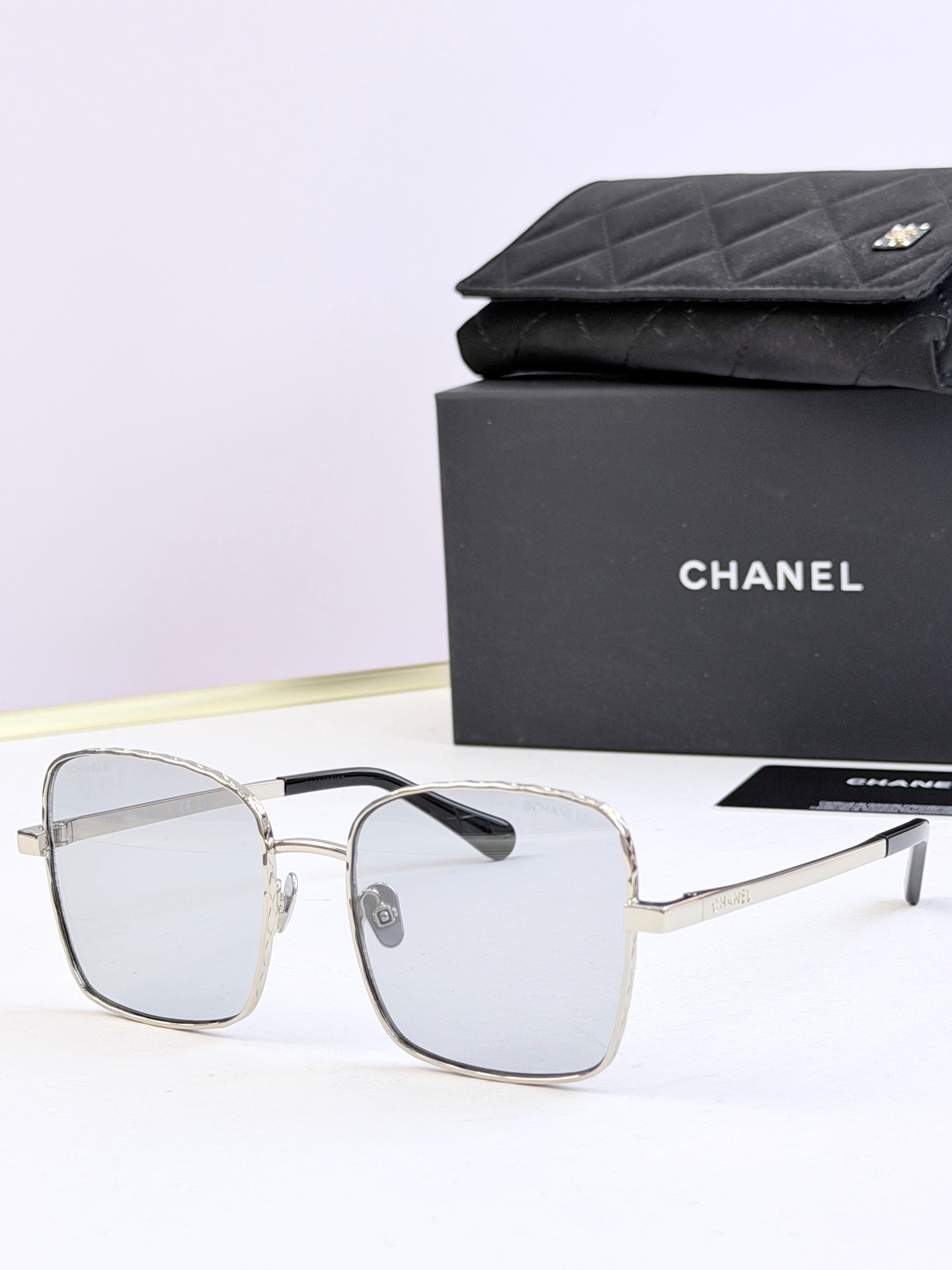 Chanel square eyeglasses with clear frames and light tinted lenses
