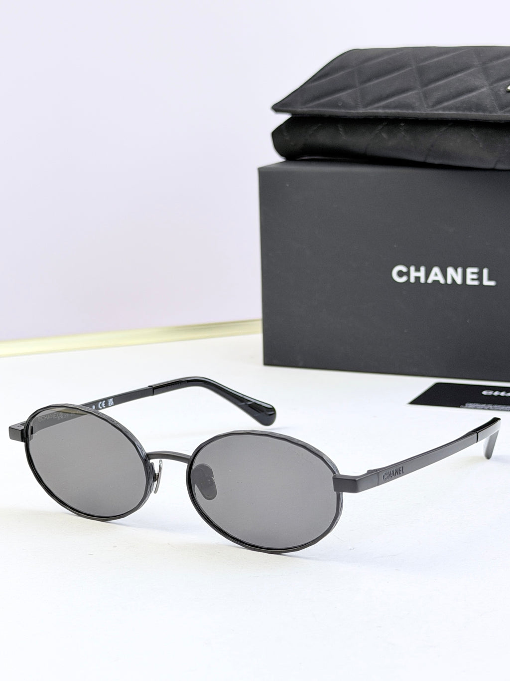 Chanel glasses with black round frames and dark gray lenses