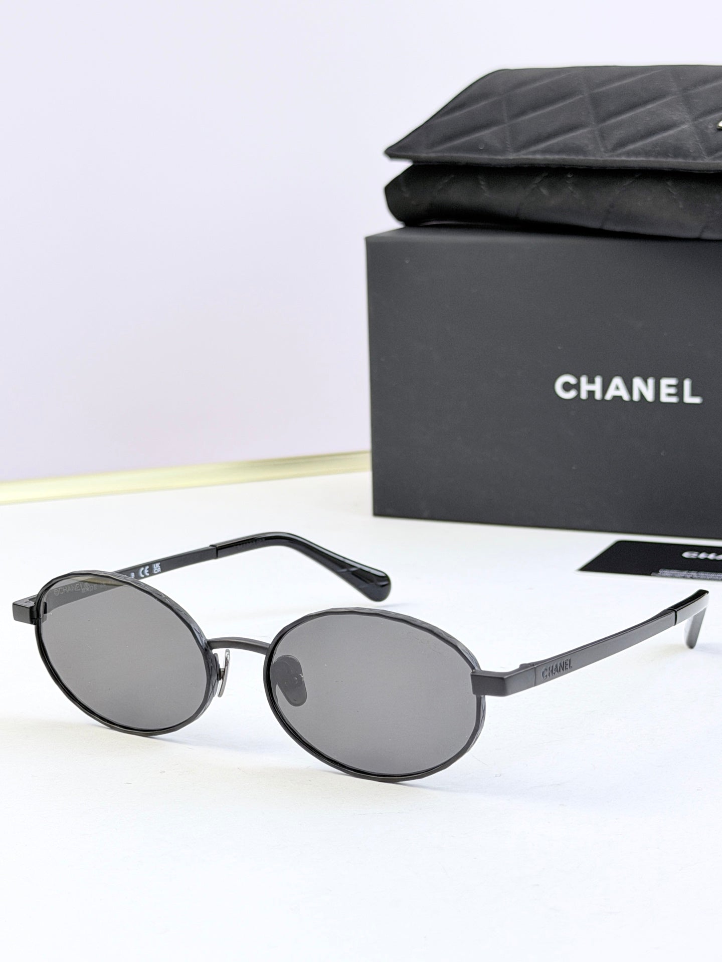 Chanel glasses with black round frames and dark gray lenses