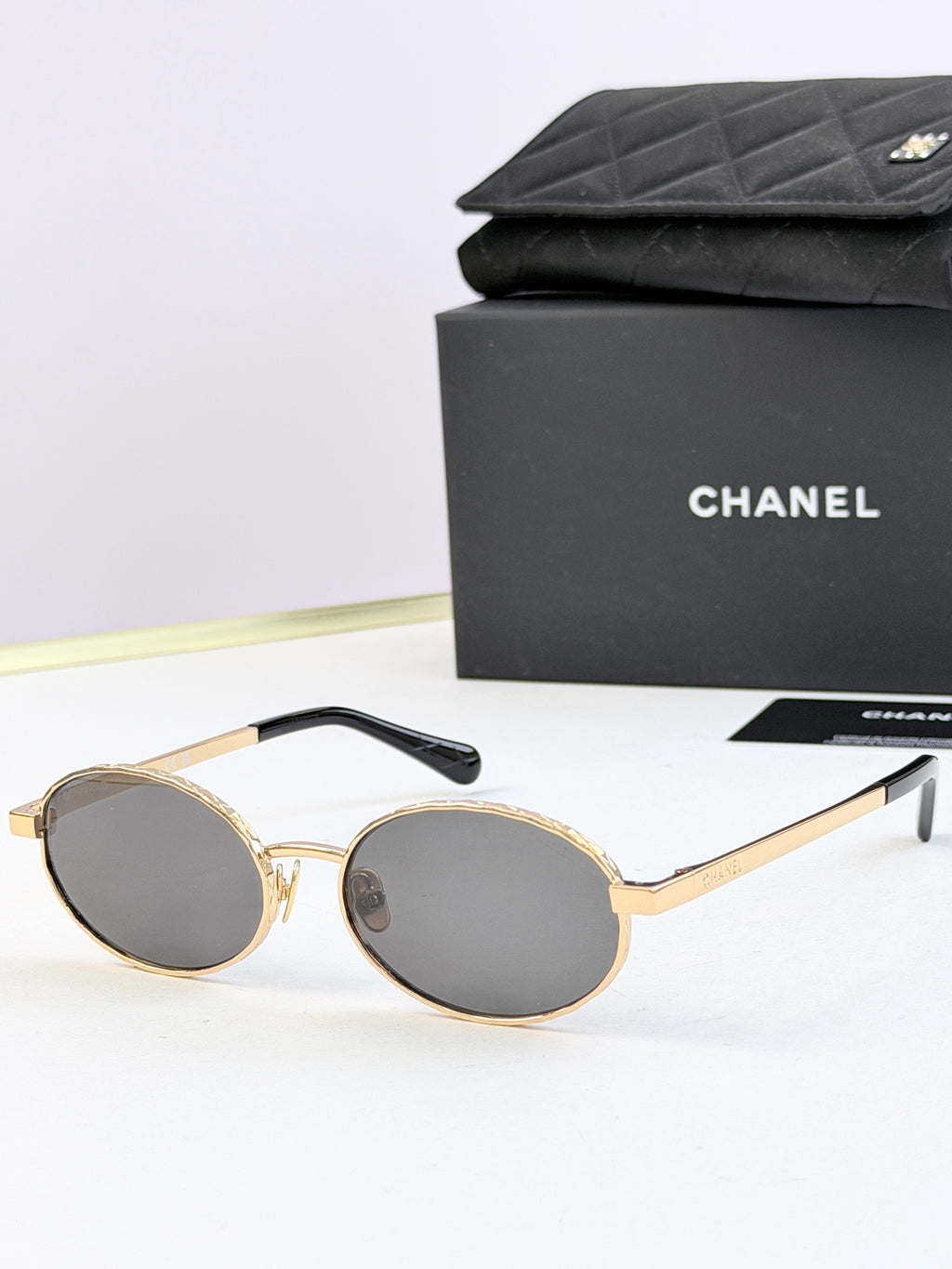 Chanel glasses with gold round frames and dark lenses