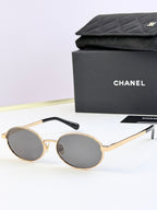 Chanel glasses with gold round frames and dark lenses