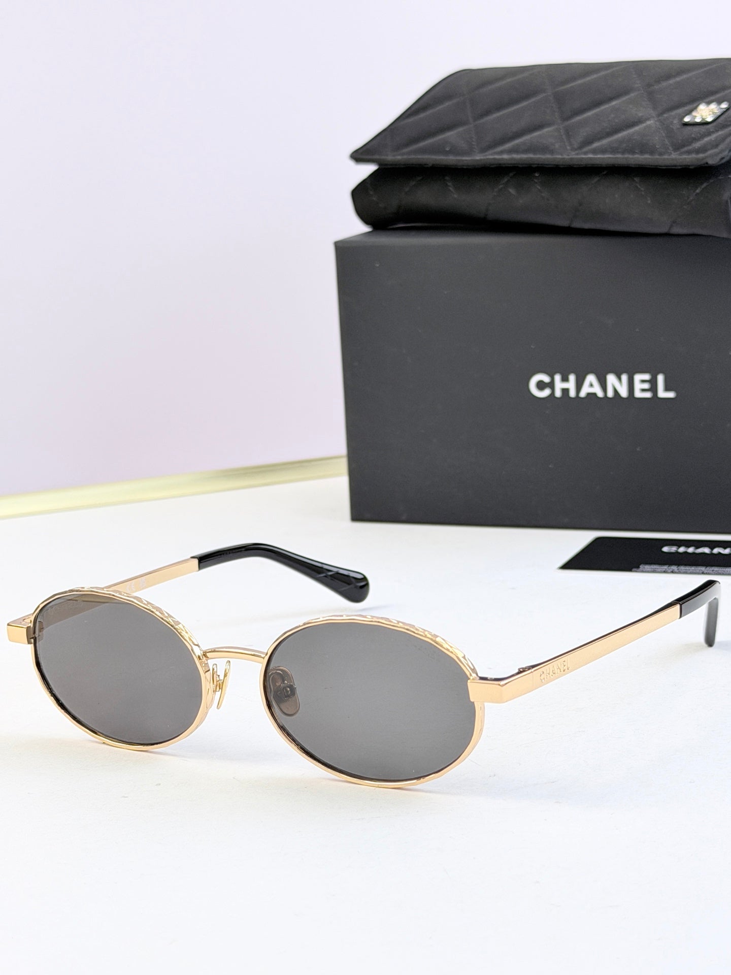 Chanel glasses with gold round frames and dark lenses