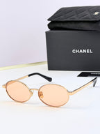 Chanel glasses with gold round frames and light rose lenses