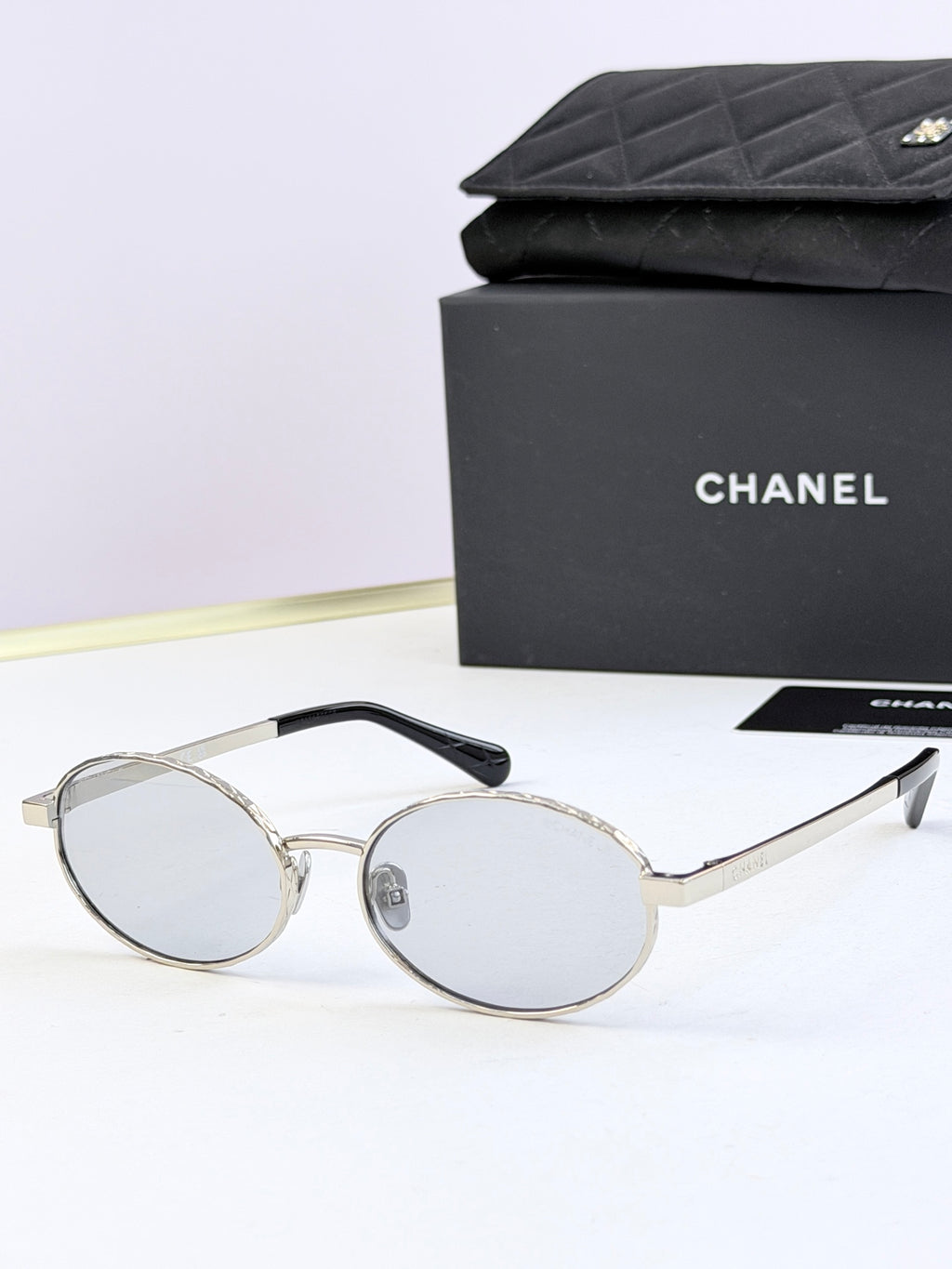 Chanel glasses with silver round frames and clear lenses
