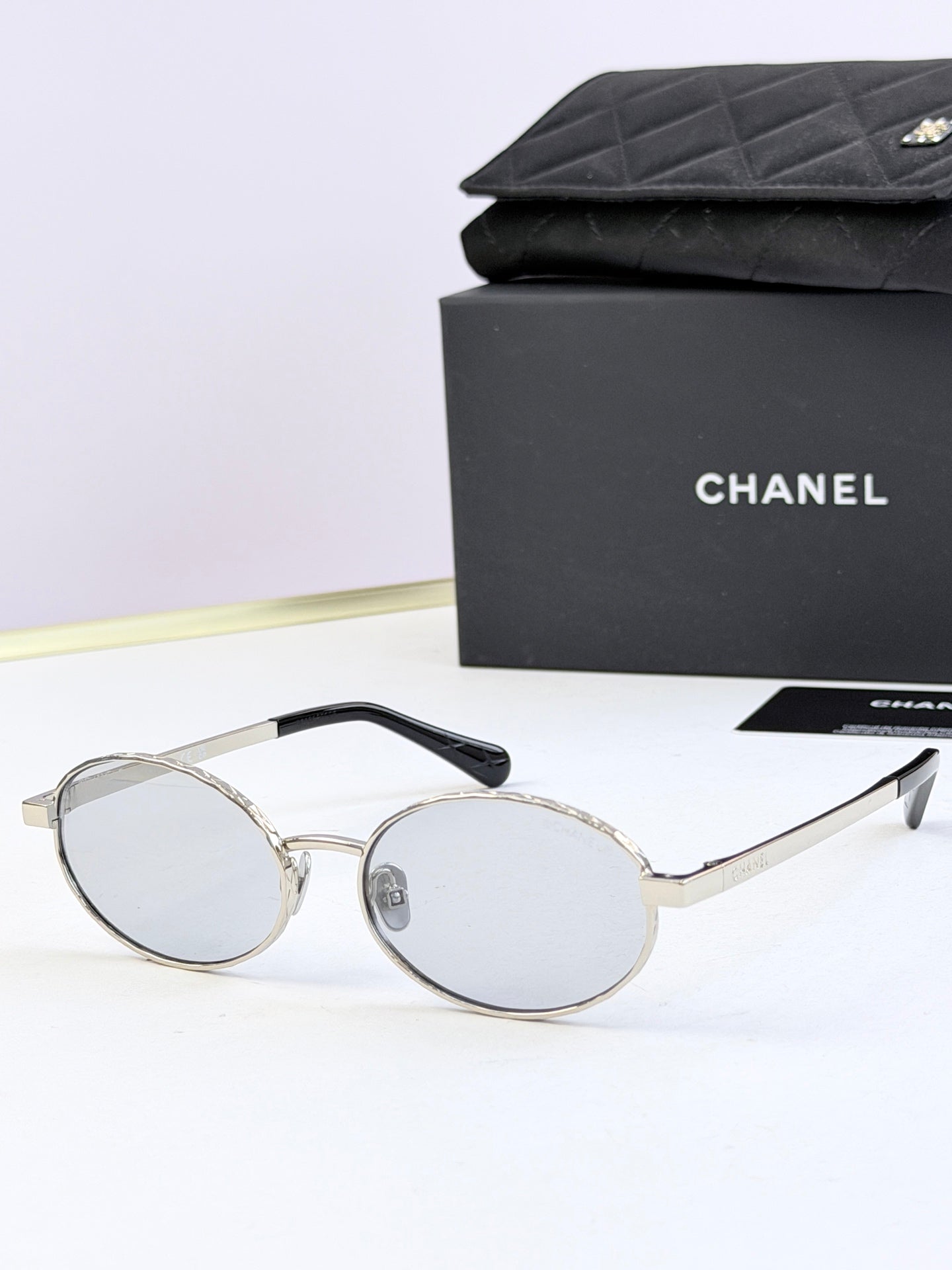 Chanel glasses with silver round frames and clear lenses