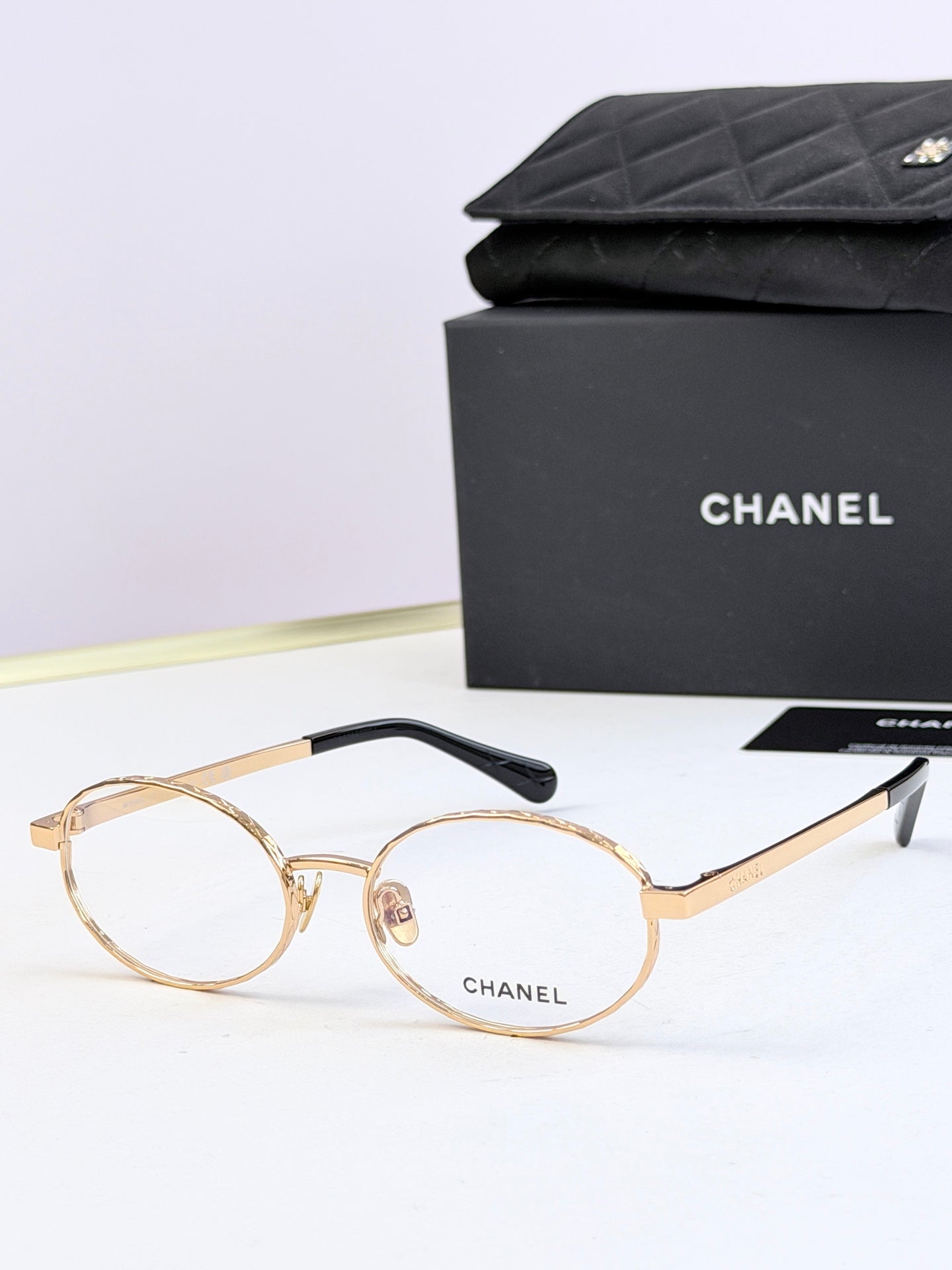 Chanel glasses with gold round frames and clear lenses