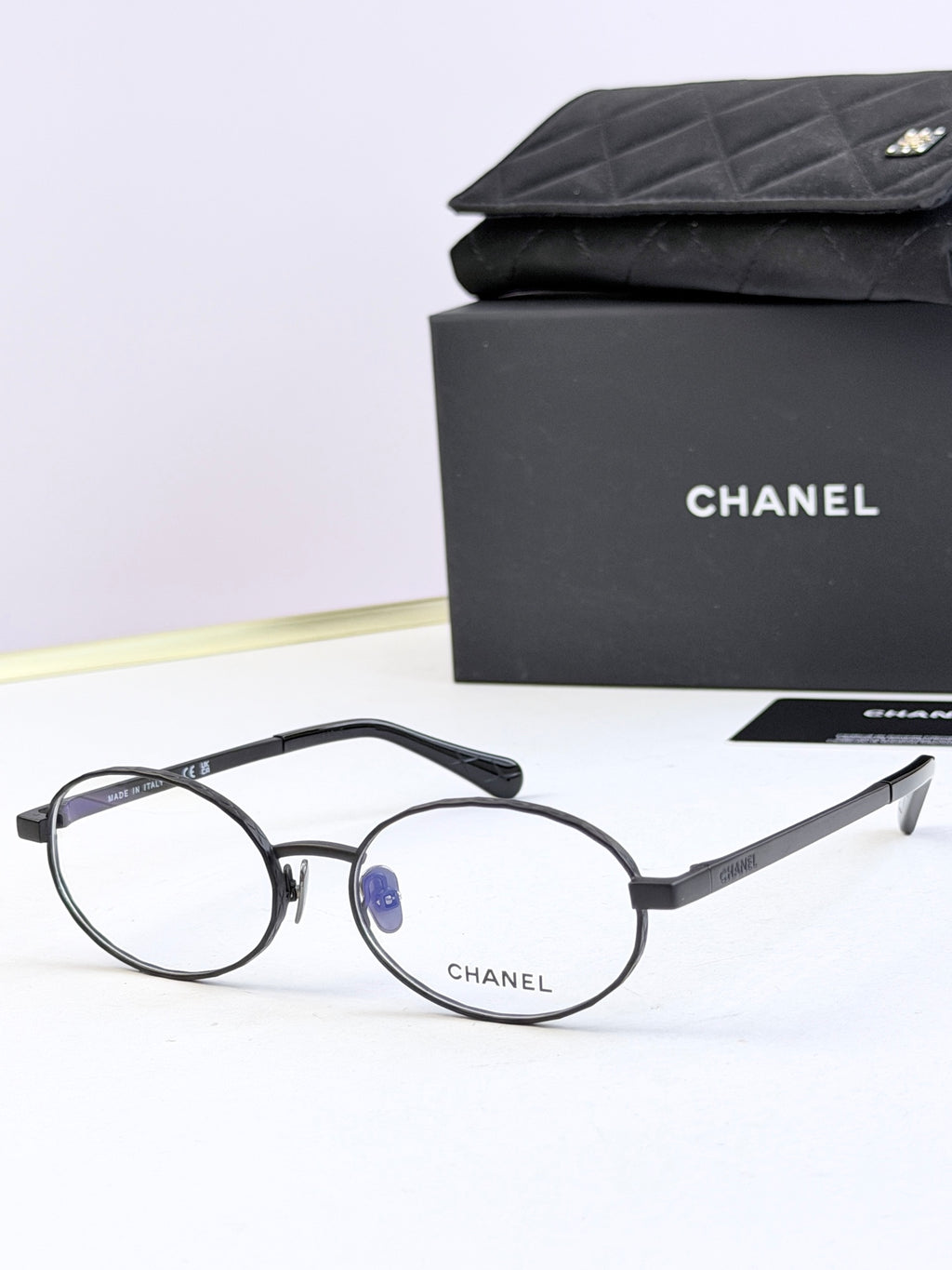 Chanel glasses with black round frames and clear lenses