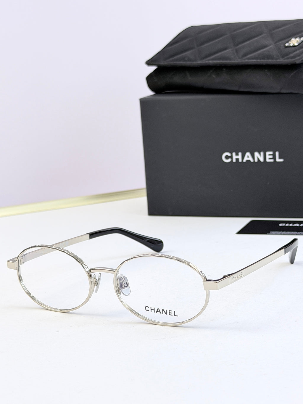 Chanel glasses with silver round frames and clear lenses