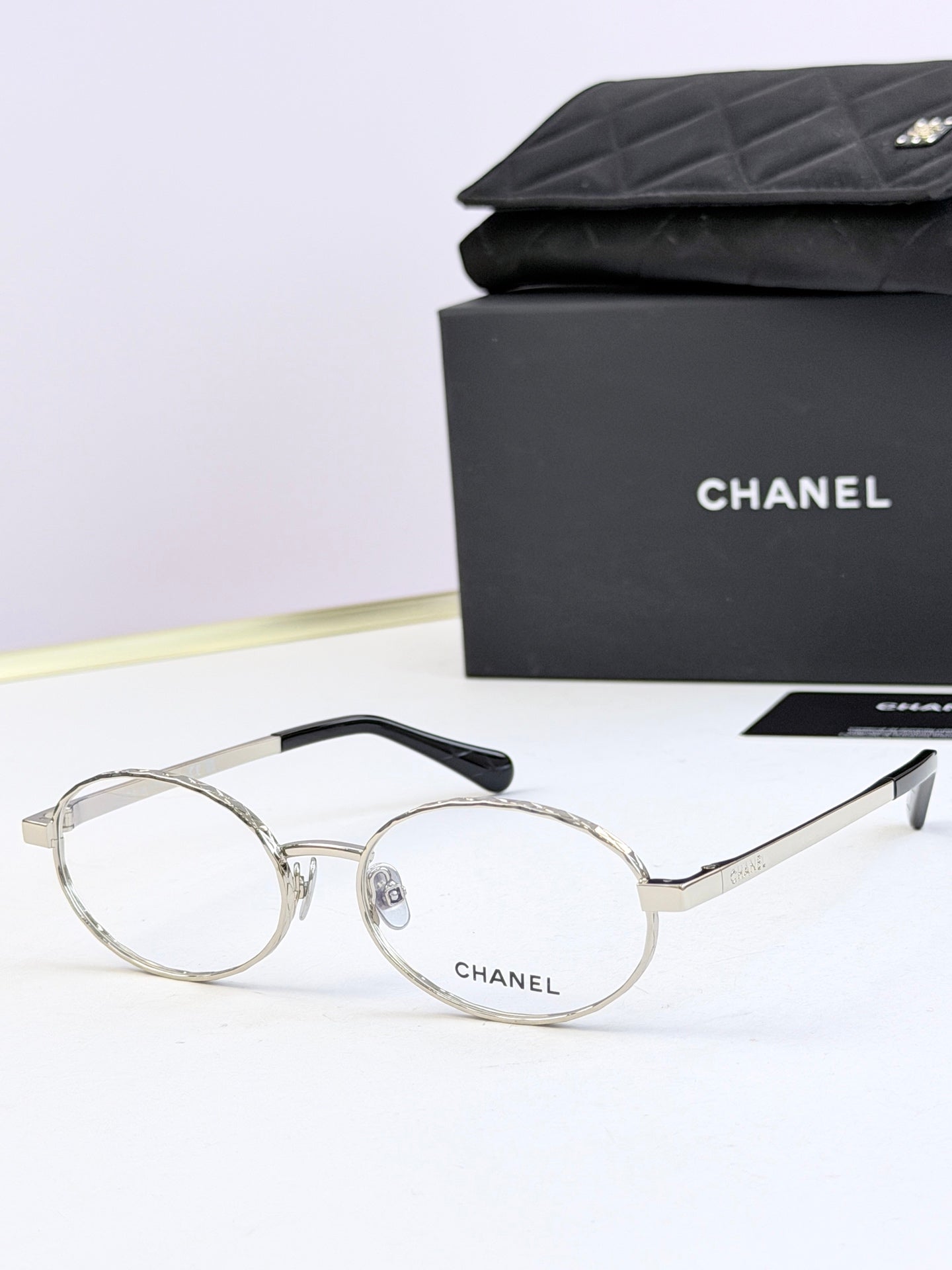 Chanel glasses with silver round frames and clear lenses