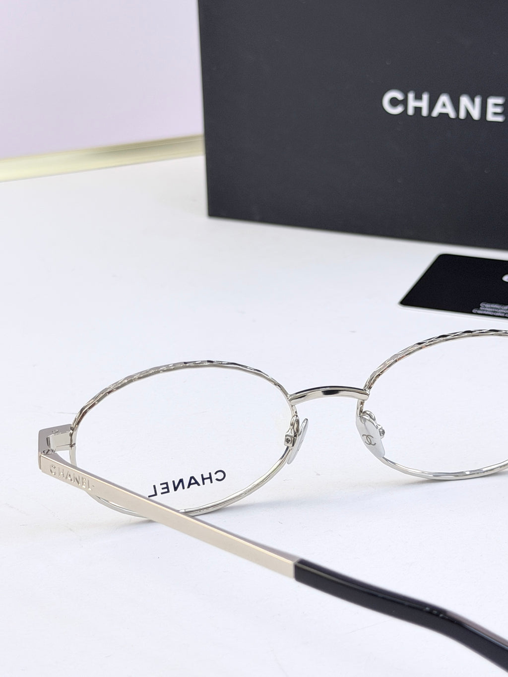 Chanel glasses close-up with silver round frames and clear lenses
