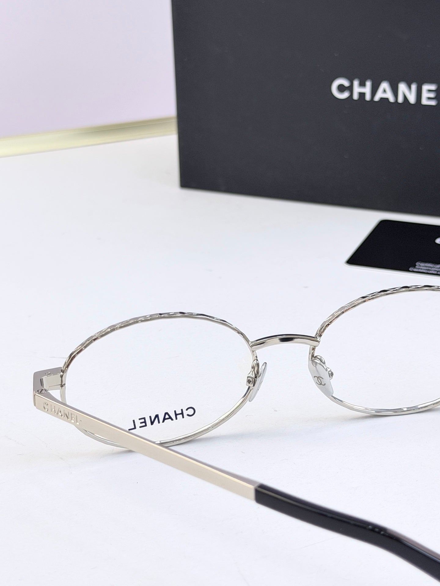 Chanel glasses close-up with silver round frames and clear lenses