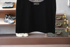 Black crewneck T-shirt hem detail with small VERSACE text near collar
