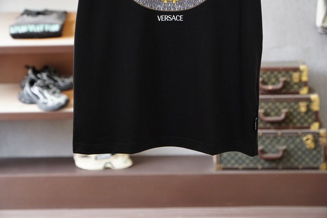Black crewneck T-shirt hem detail with small VERSACE text near collar