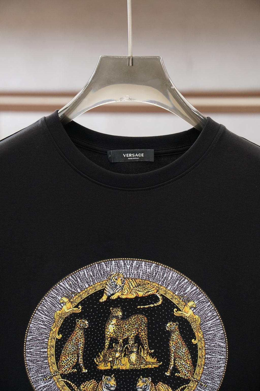 Black crewneck T-shirt with VERSACE logo on chest and crew collar