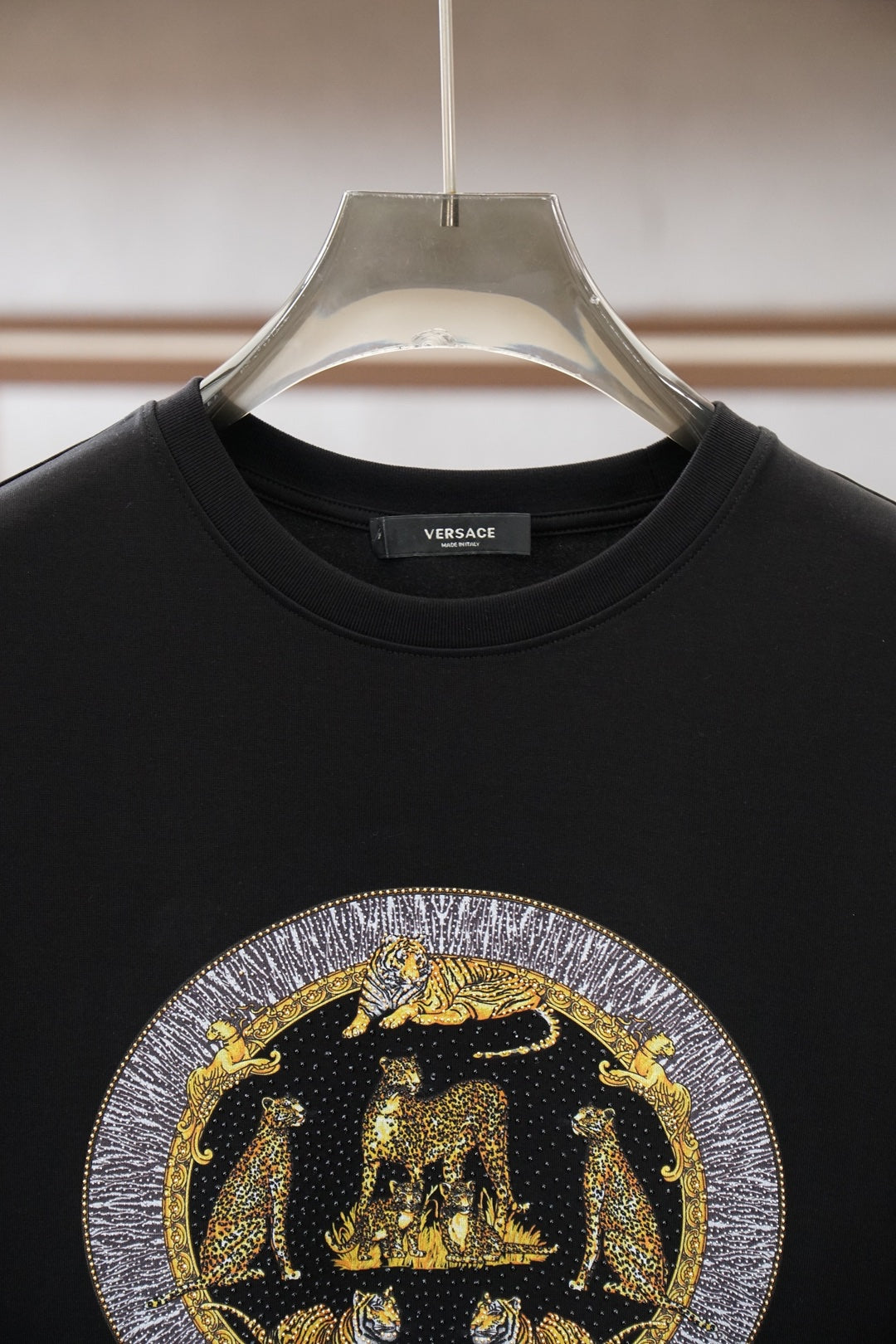 Black crewneck T-shirt with VERSACE logo on chest and crew collar