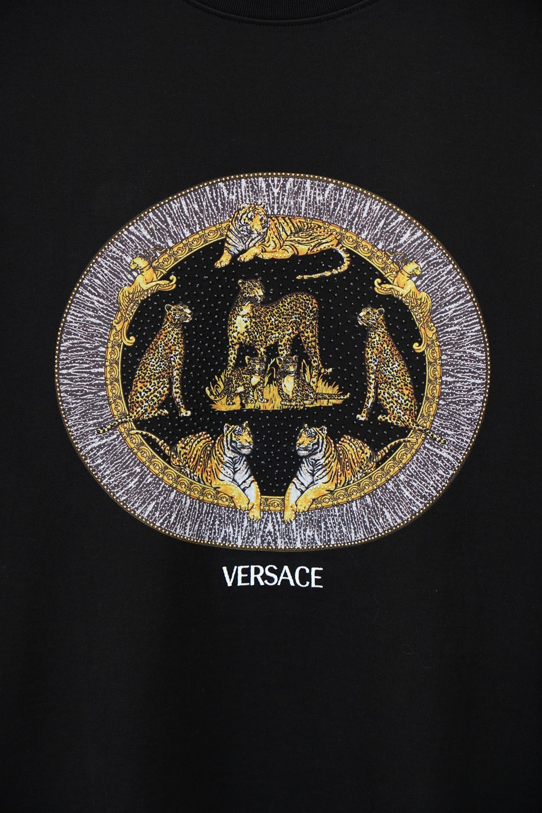 Black Versace crewneck T-shirt with gold emblem graphic and VERSACE text