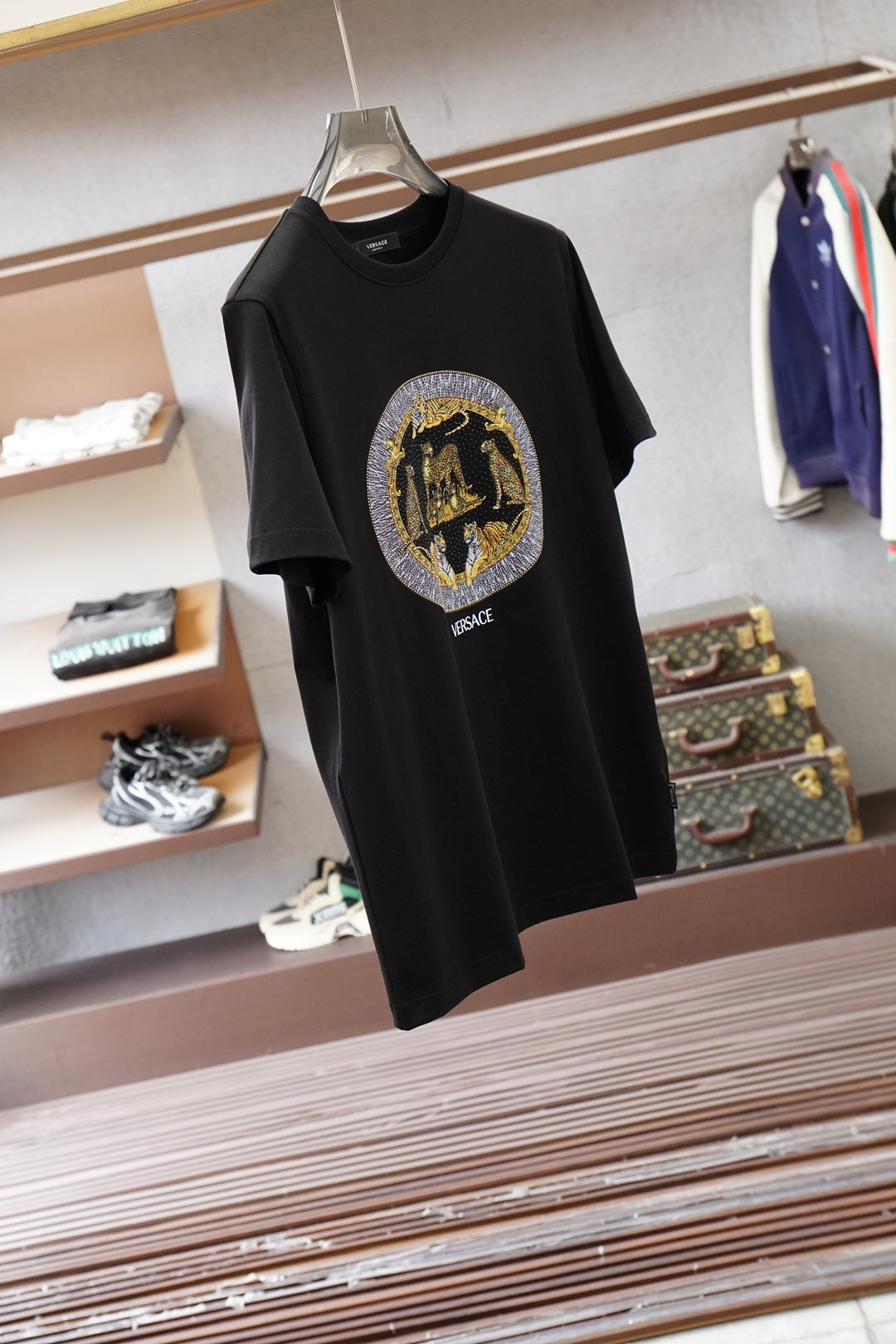 Black Versace crewneck T-shirt with round gold emblem logo on chest