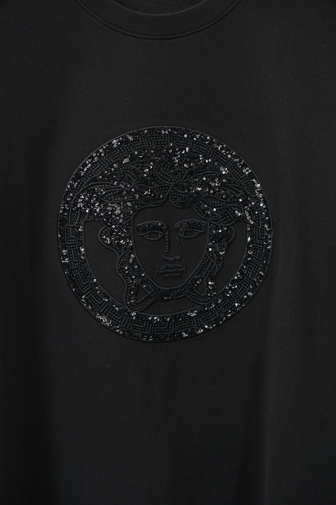 Versace black T-shirt with close-up circular rhinestone Medusa emblem