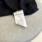 Black T-shirt interior neck label and care tag