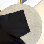 Black T-shirt sleeve hem and stitched side seam detail