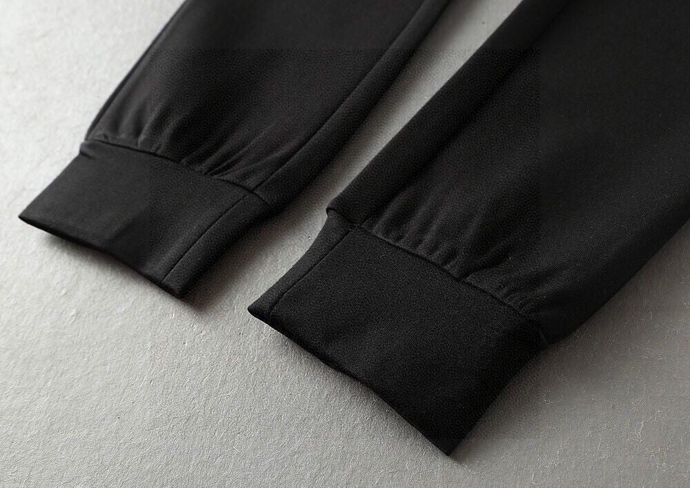 Black jogger pant hems with elastic cuffs, seam detail on cuffs