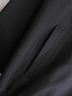 Black fabric close-up with visible side seam and smooth matte finish