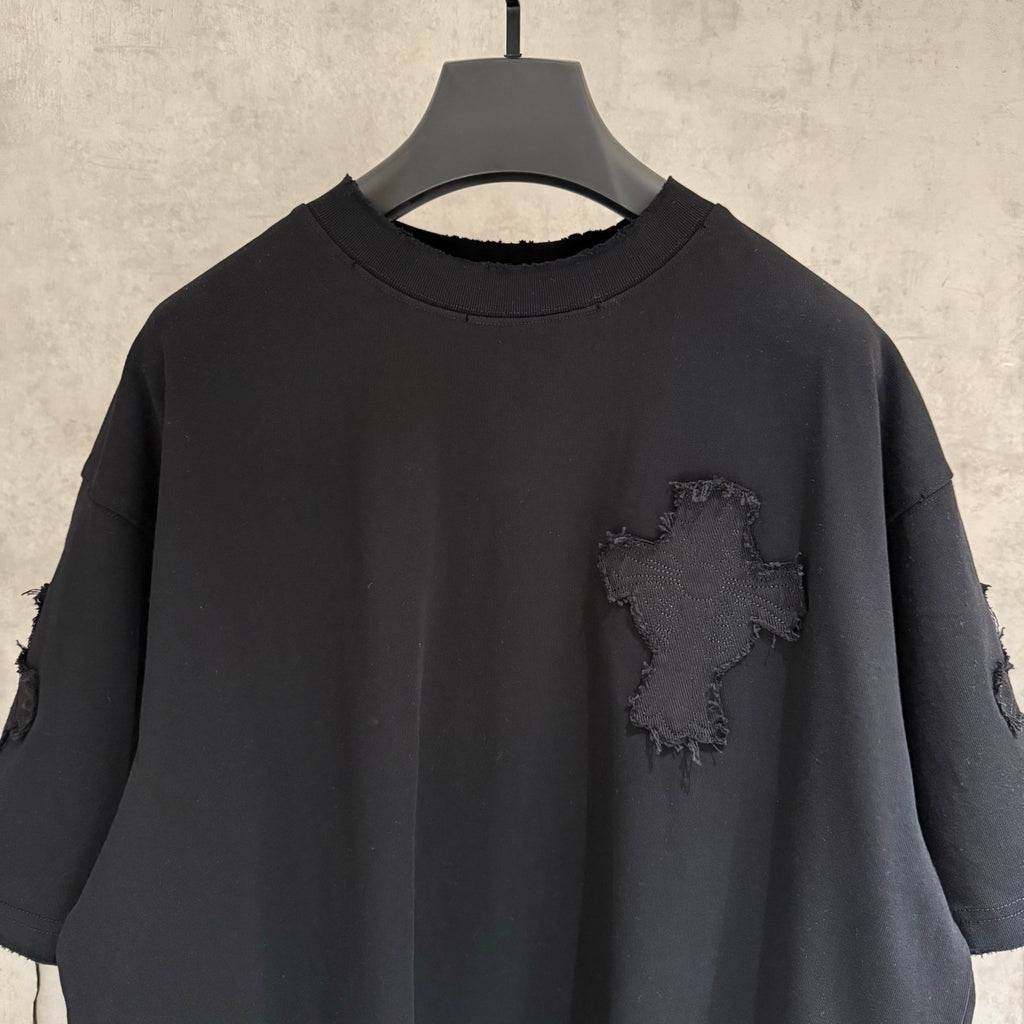 Black short-sleeve T-shirt close-up of crew neck and small chest cross patch