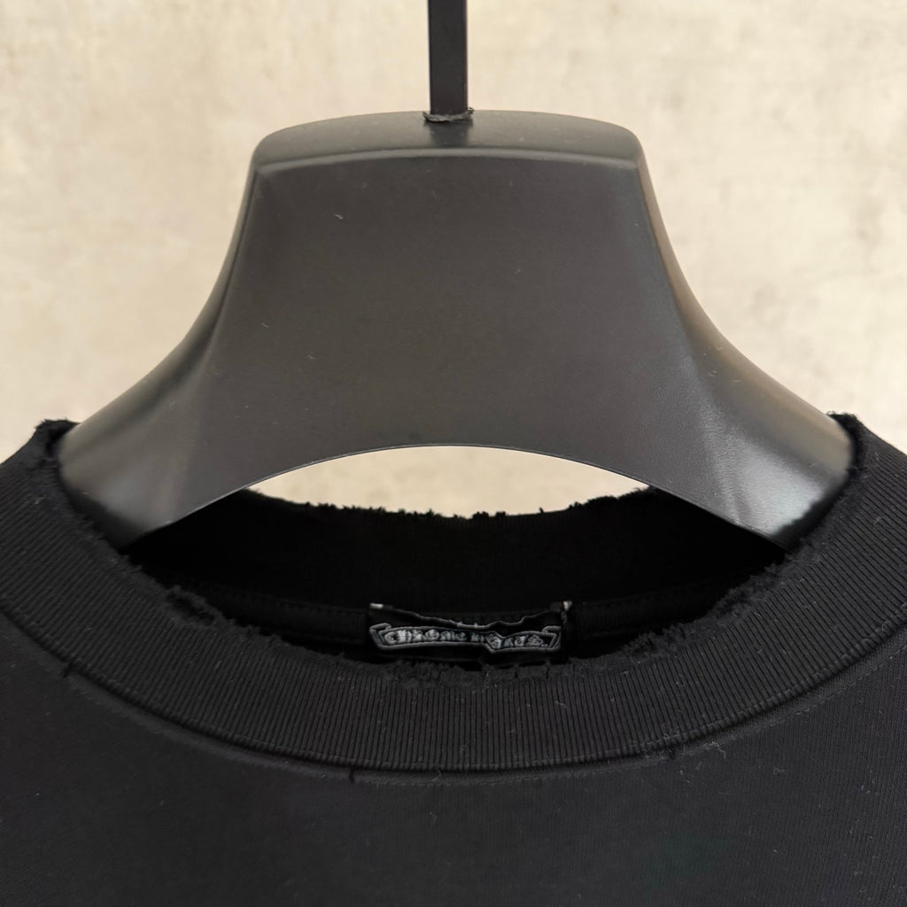 Black short-sleeve T-shirt close-up of ribbed crew neck with inner label