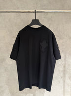 Black short-sleeve T-shirt with distressed sleeves and small cross applique on chest