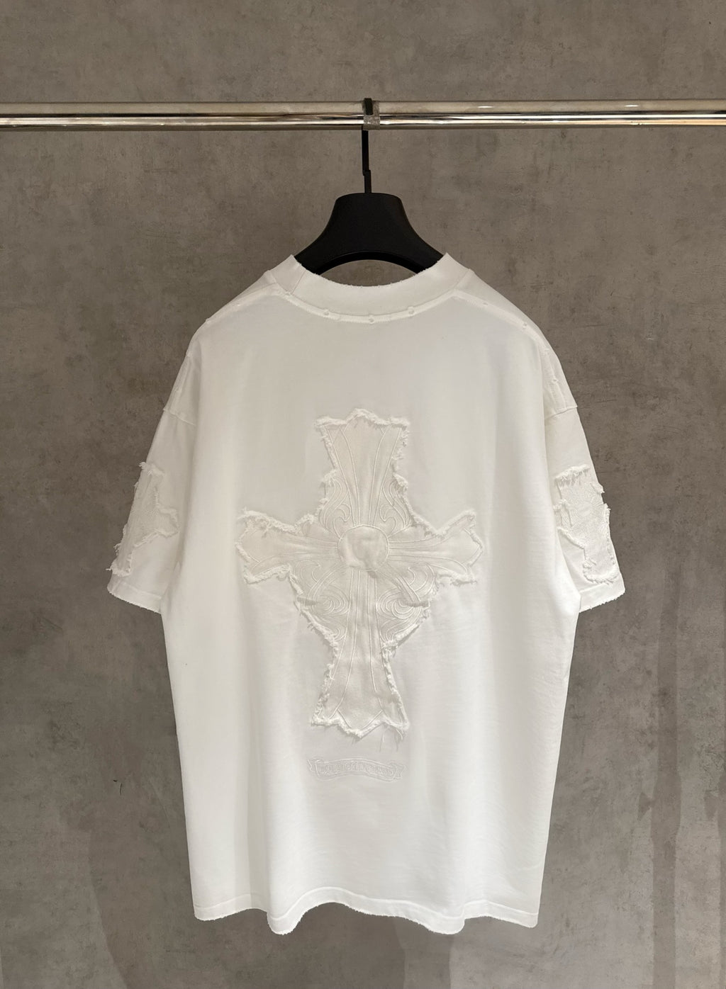 White short-sleeve T-shirt with large embroidered cross design on the back