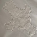Embroidered cross applique on a white short-sleeve T-shirt